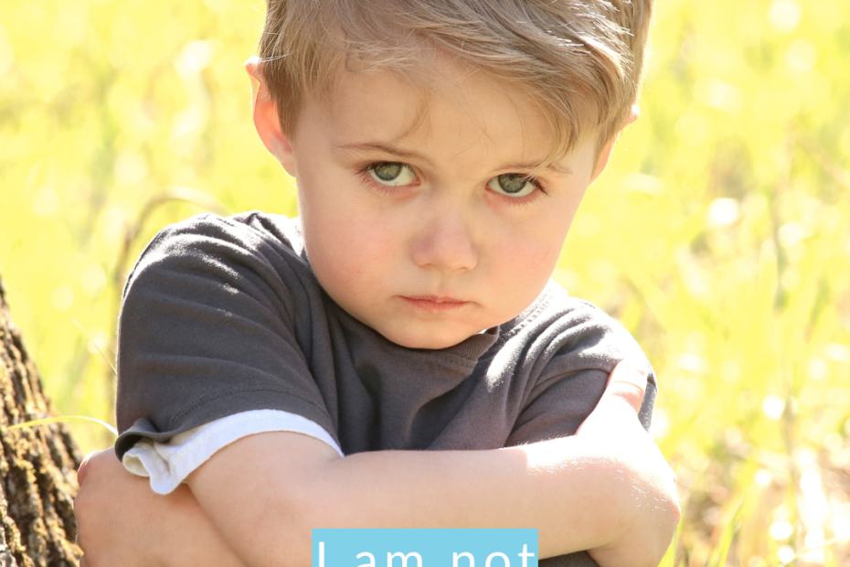 A little boy looking straight at the camera, sad and a little defiant with his arms folded tight around himself. The words "I am not a problem to be solved are printed at the bottom." Illustrating the importance of unconditional love in post-Mormon parenting.