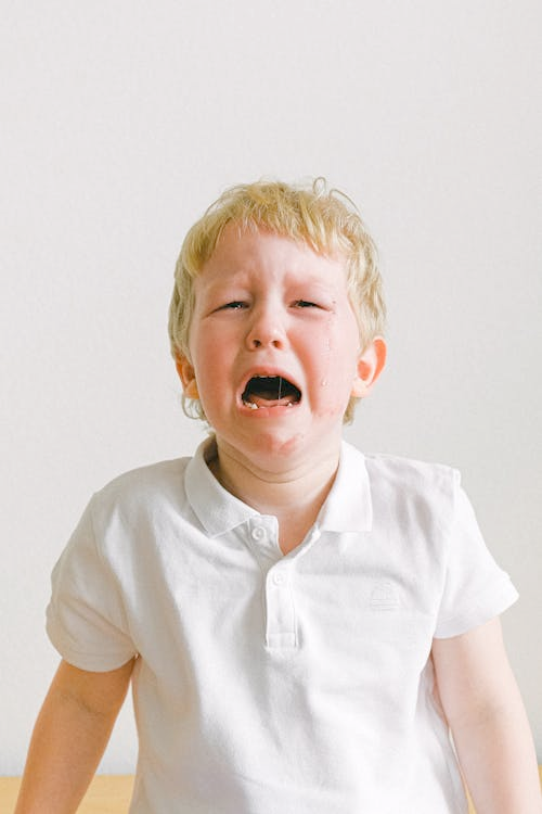 A young boy is crying, illustrating the need for emotional regulation in post-Mormon parenting.